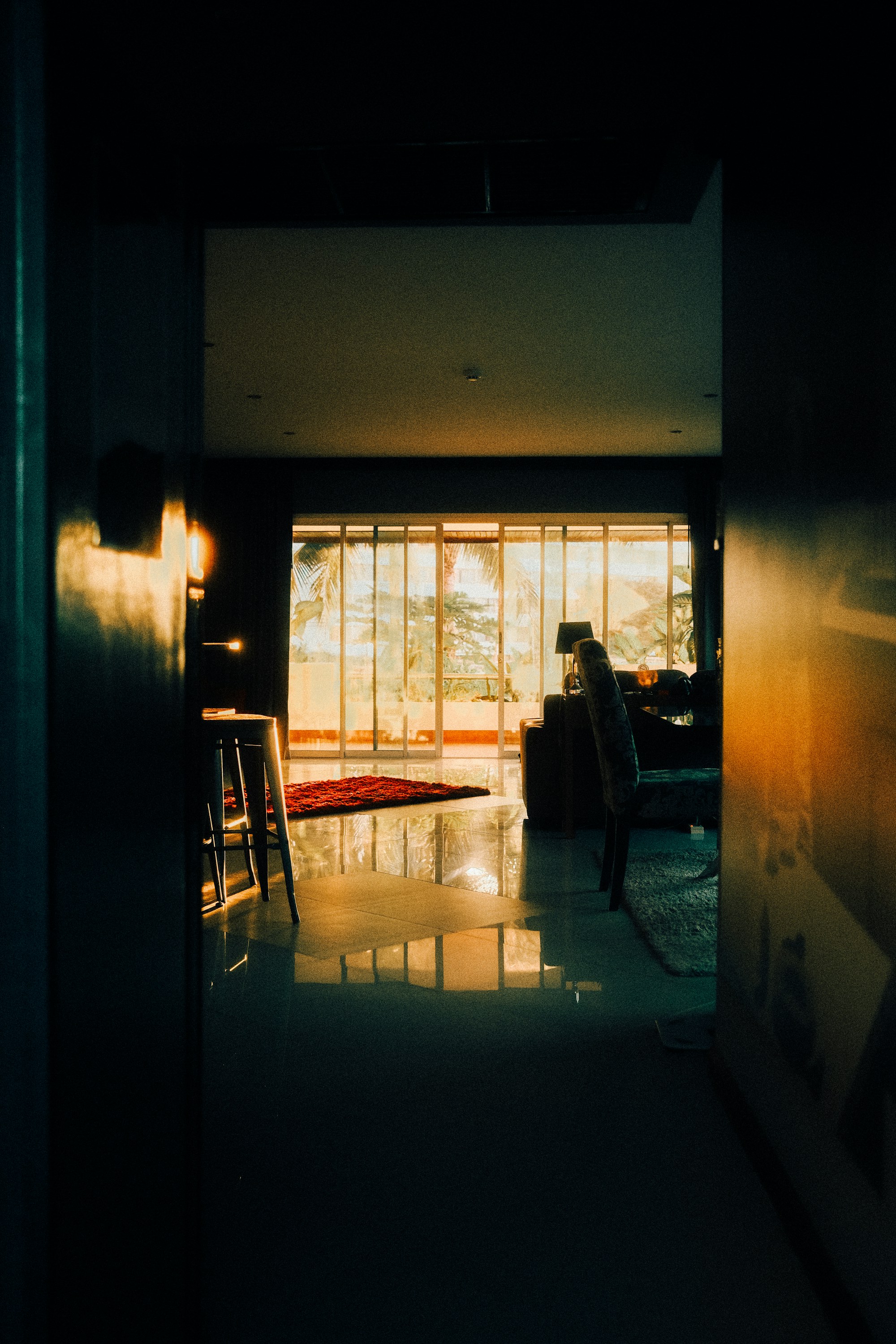 Moody interior with golden afternoon light crossing a dark room